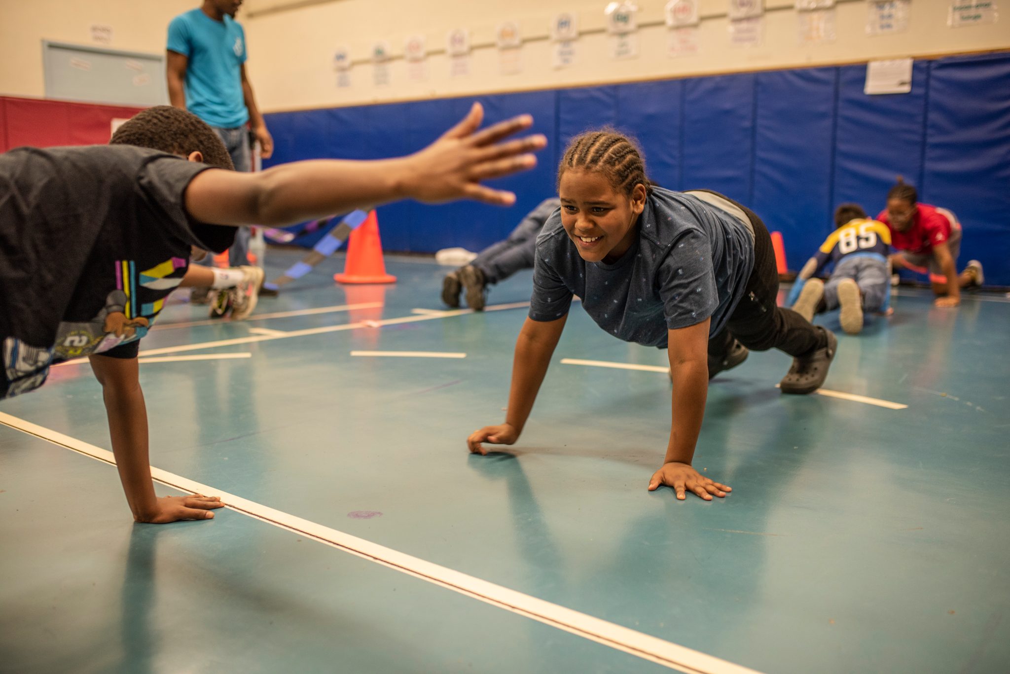 A push-up and a reach across the gym floor.