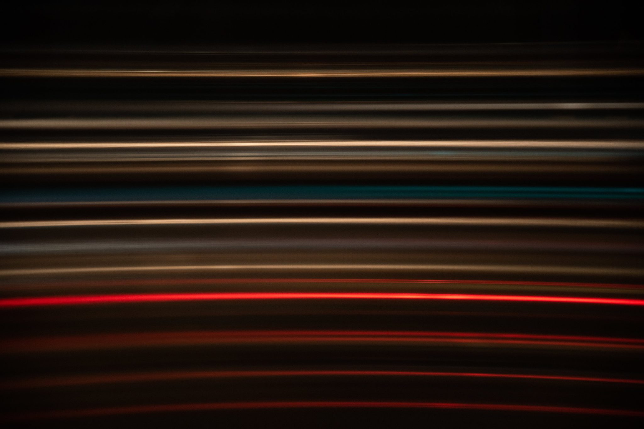 The train streaks past in ribbons of light. We are all planets, gravity bound to our star, pushing and pulling.