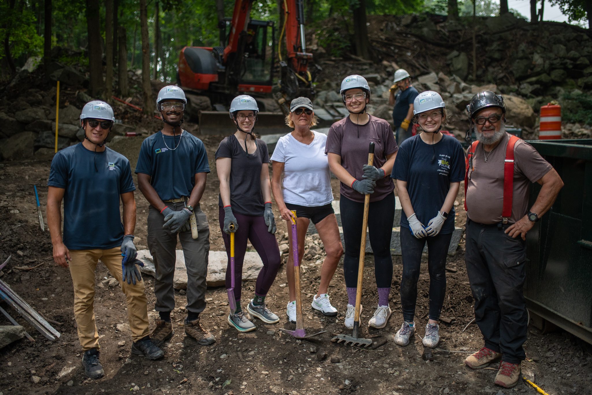 The crew gathers for a picture below the new steps, tools in hand.