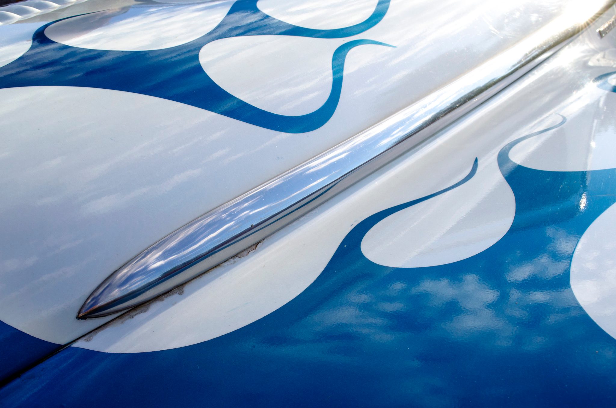 Blue flames painted along a chrome-trimmed hood.
