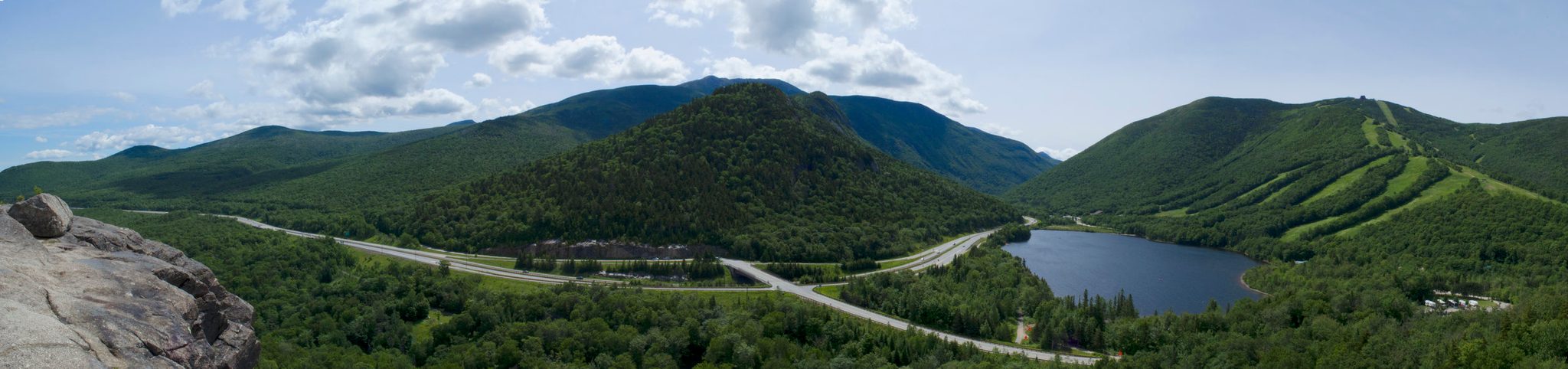 Green mountains ring a small lake and the winding road through the notch.
