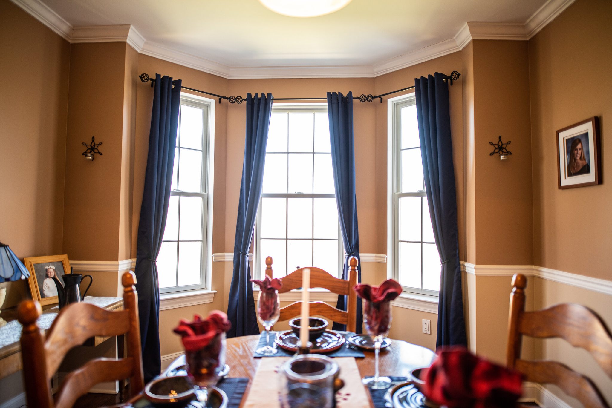 Navy drapes frame the bay windows, and the table is already set.