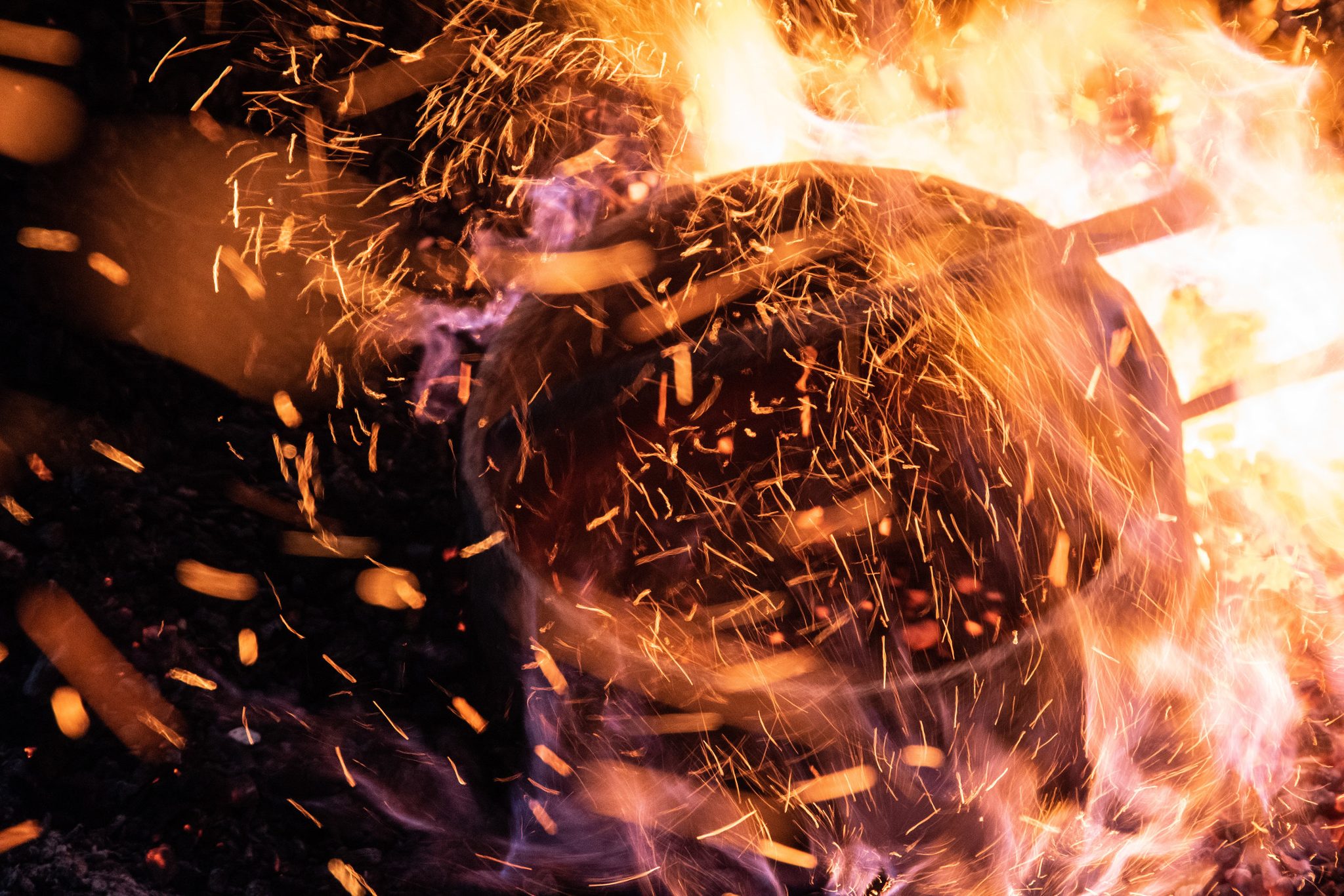 In the heart of the fire, the crucible glows through a storm of sparks.