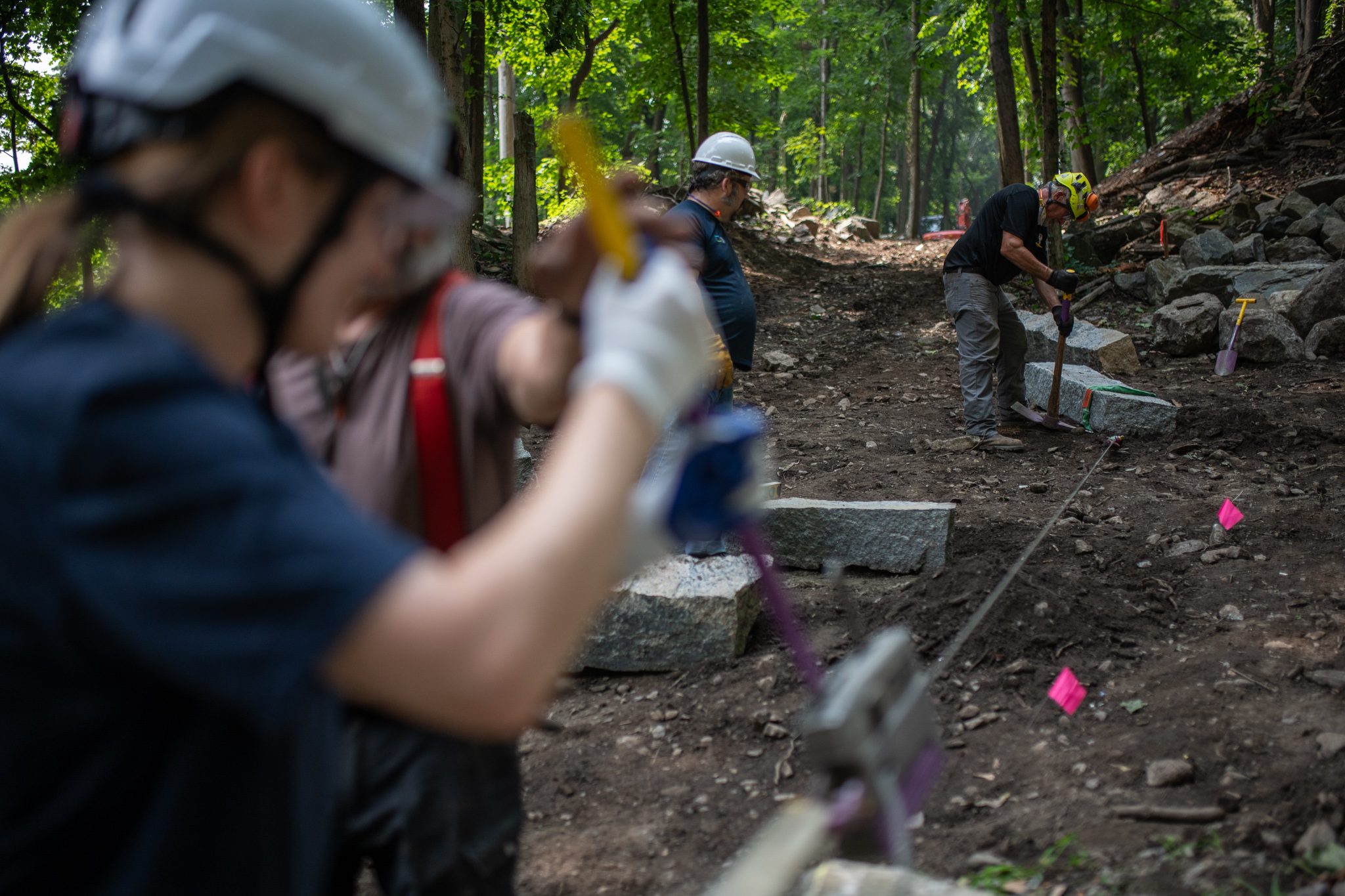 Hands on the rope and the winch, the crew hauls the step into place.