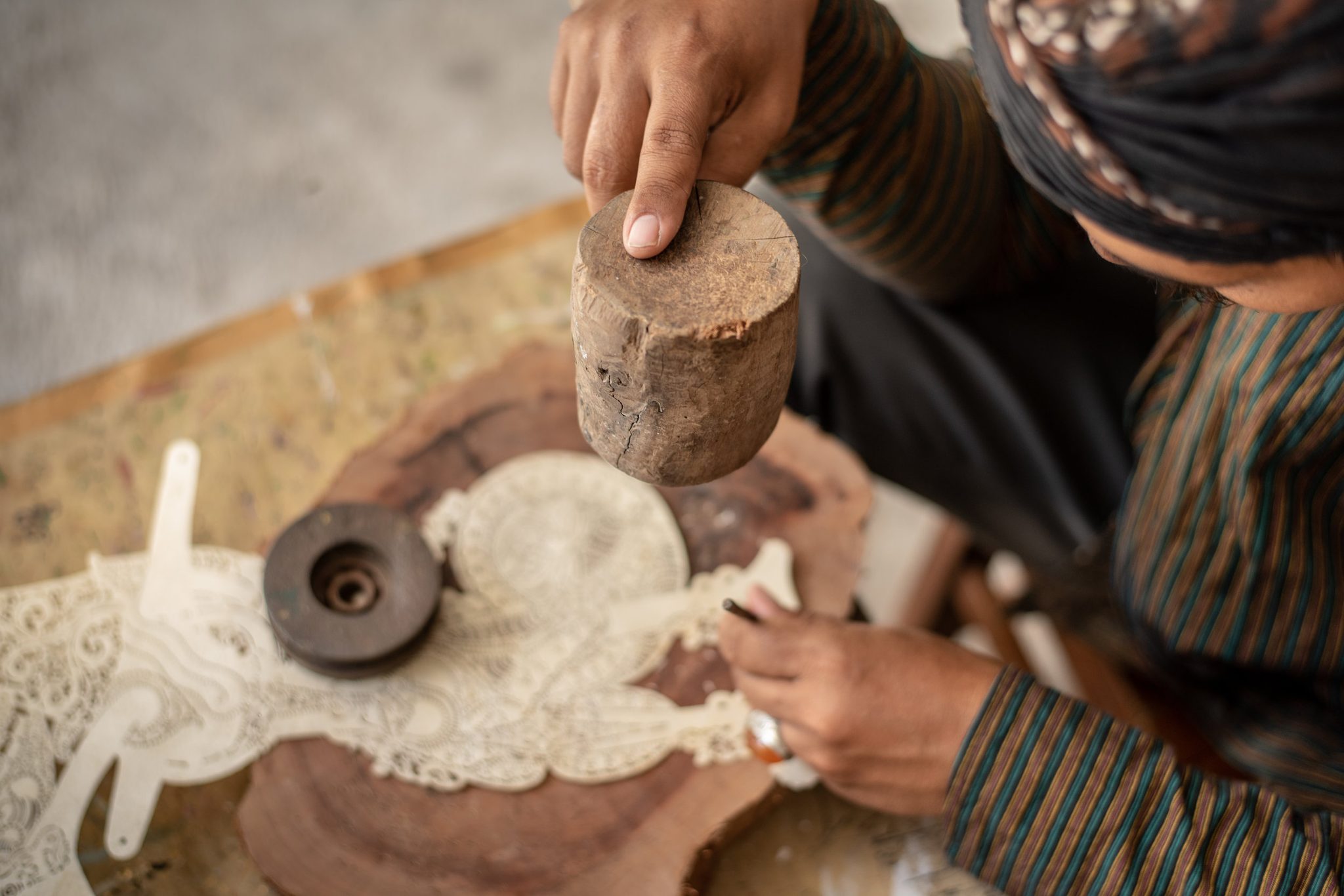 Mallet in one hand, chisel in the other, the leather turns to lace.