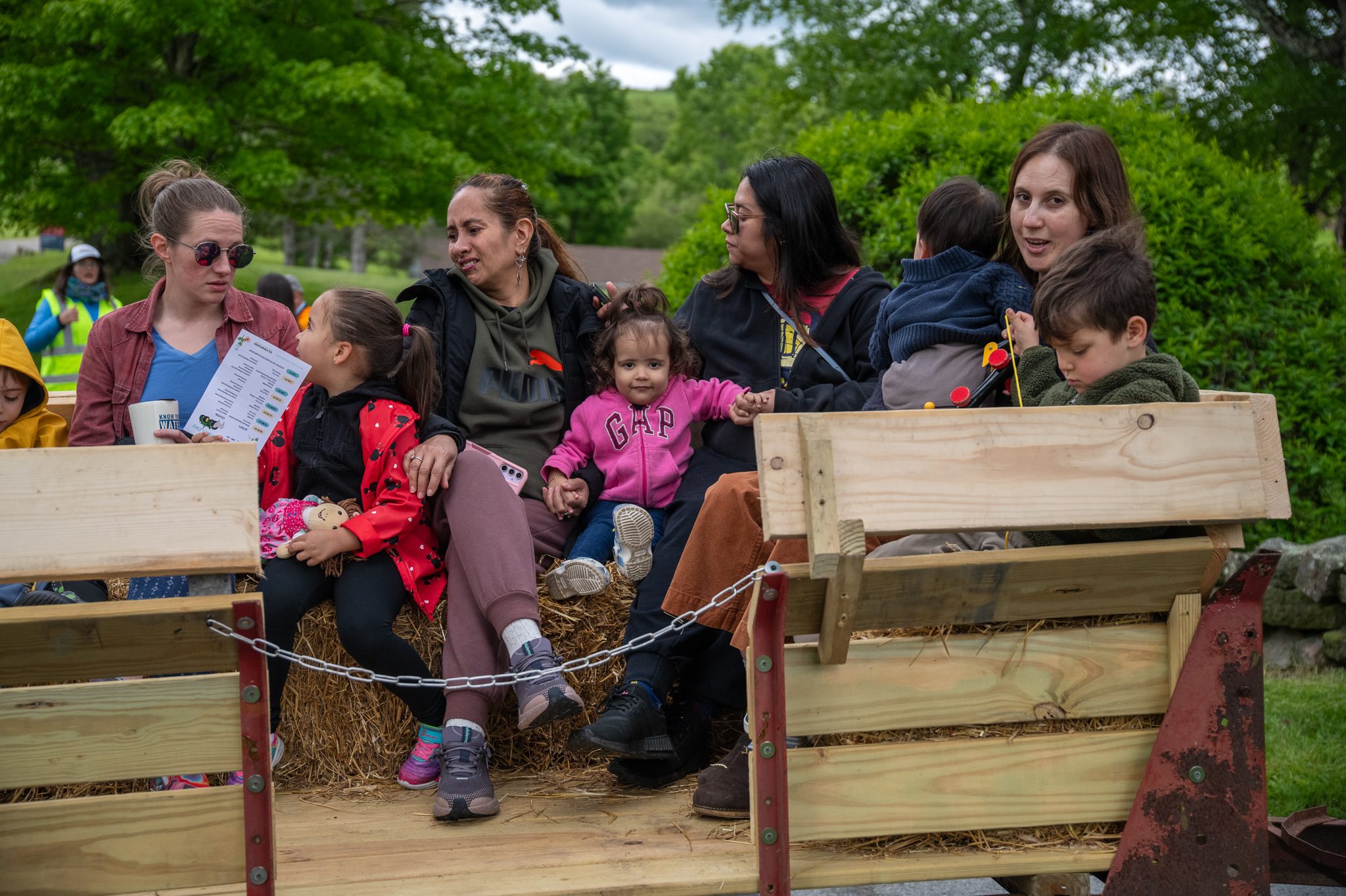 Families pack the hay wagon, ready to roll.