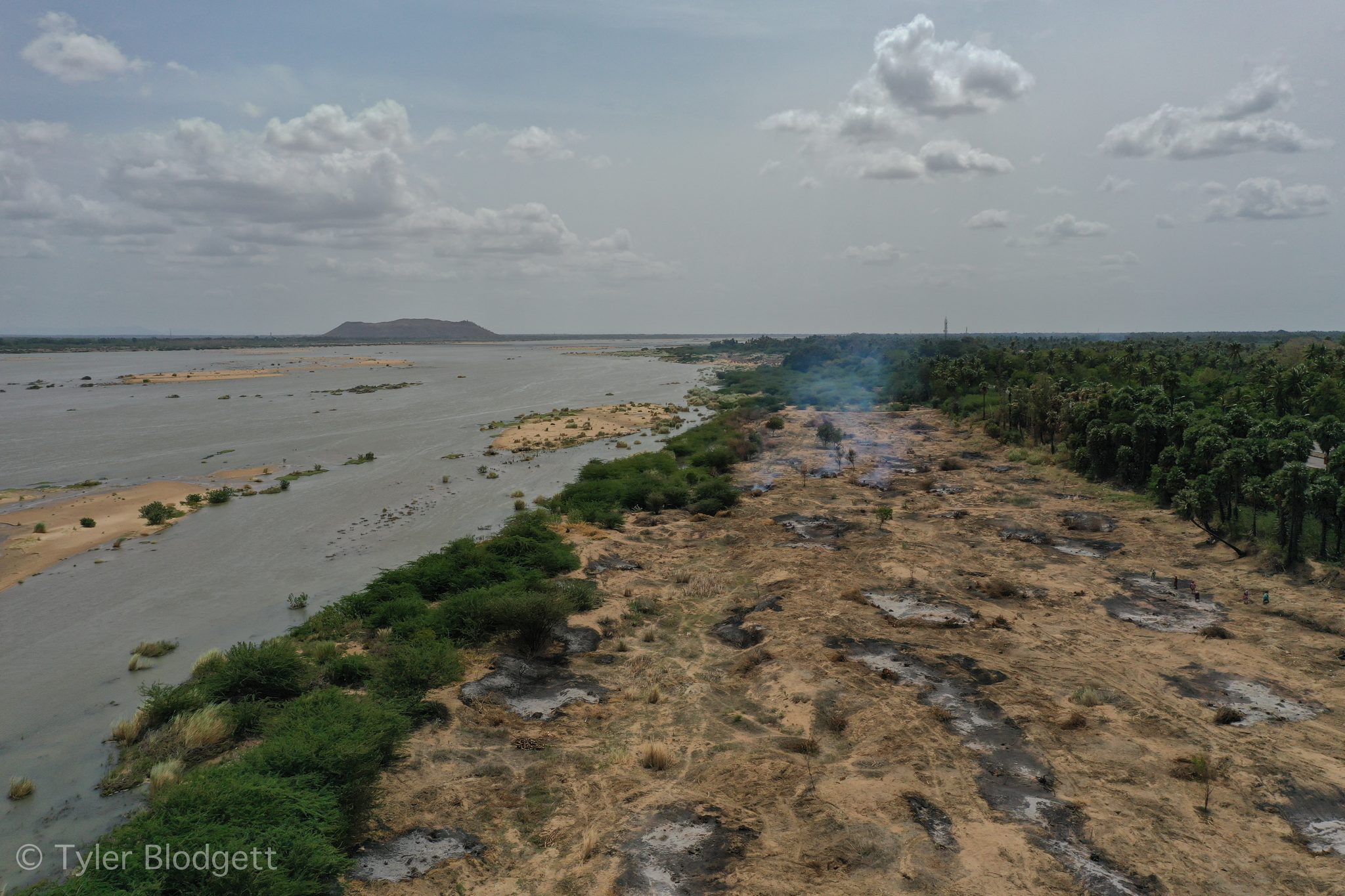 The riverbed lies scarred and bare, the water pushed to one side.