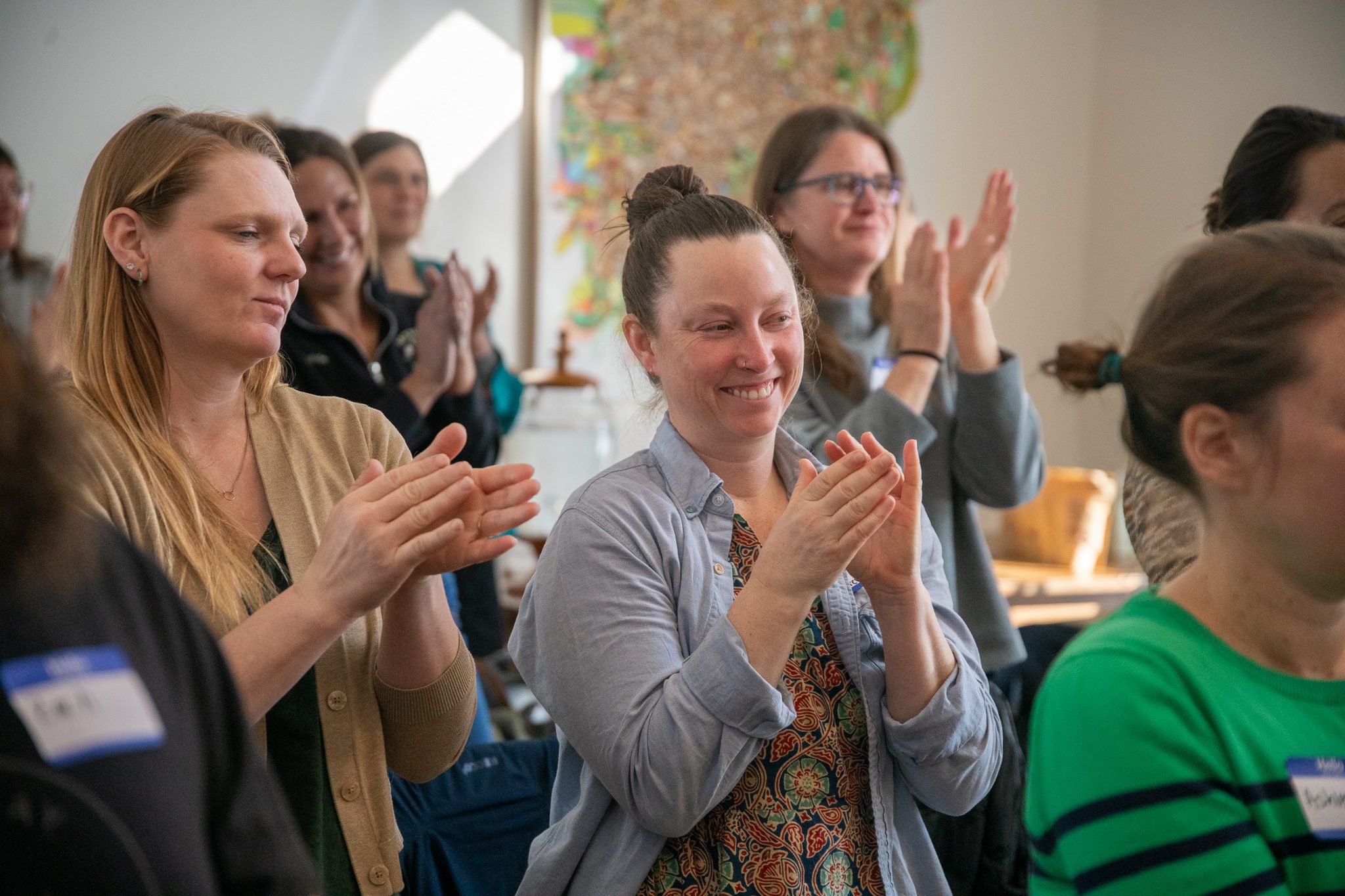 Applause from the room after a presentation.