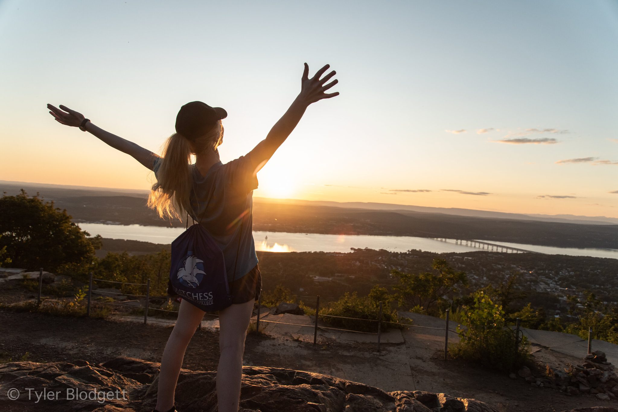 Arms flung open to the sunset, she has the whole valley to herself for a moment.