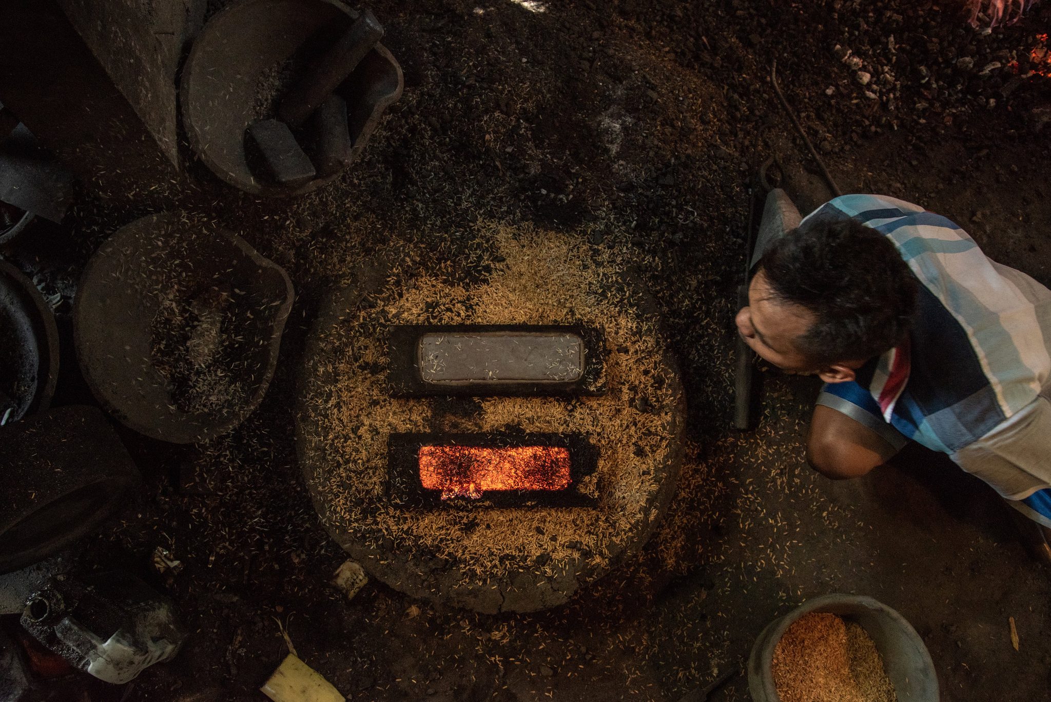 Gamelan maker blows on molten keys