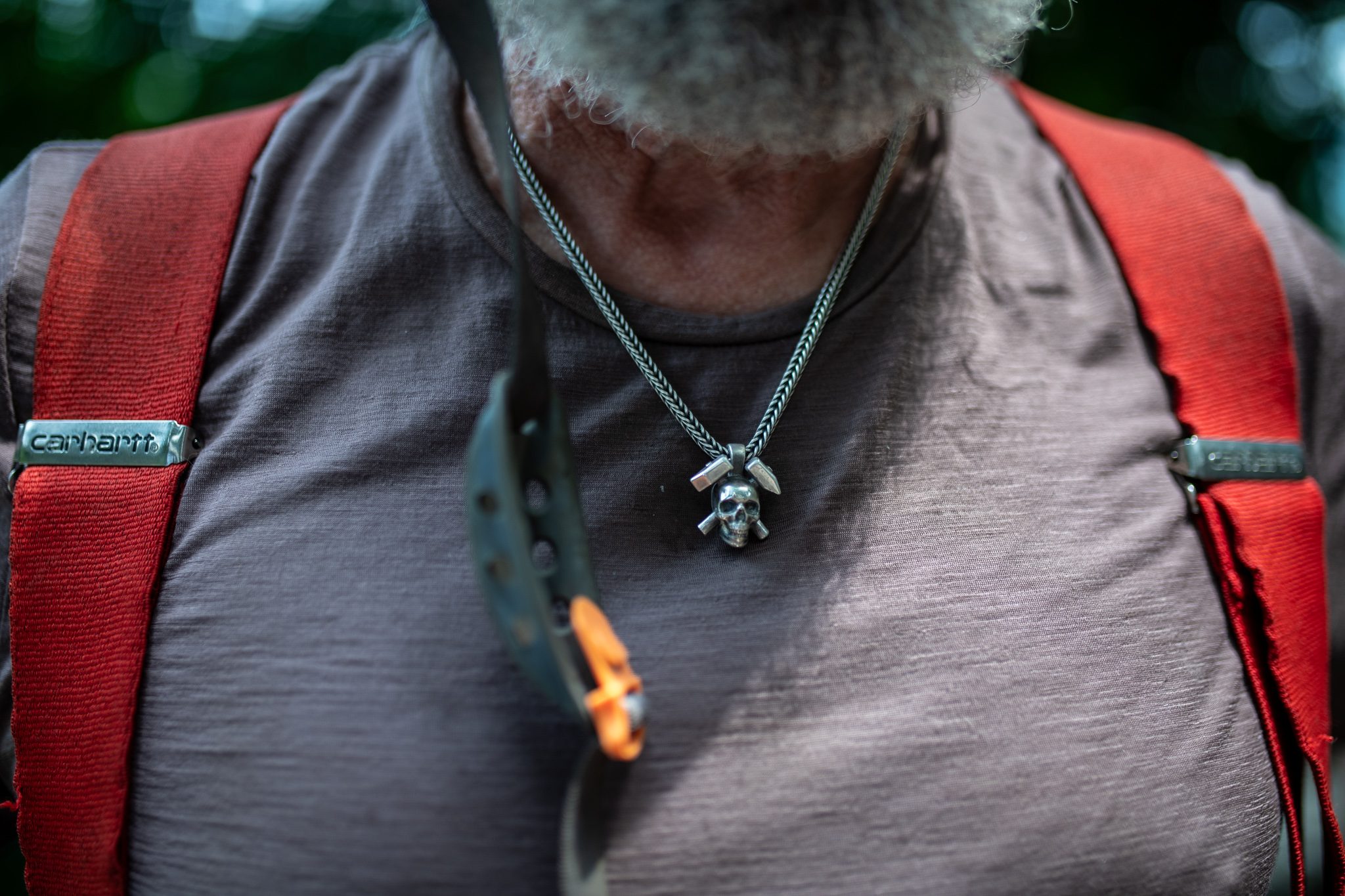A skull pendant and a pair of red suspenders.