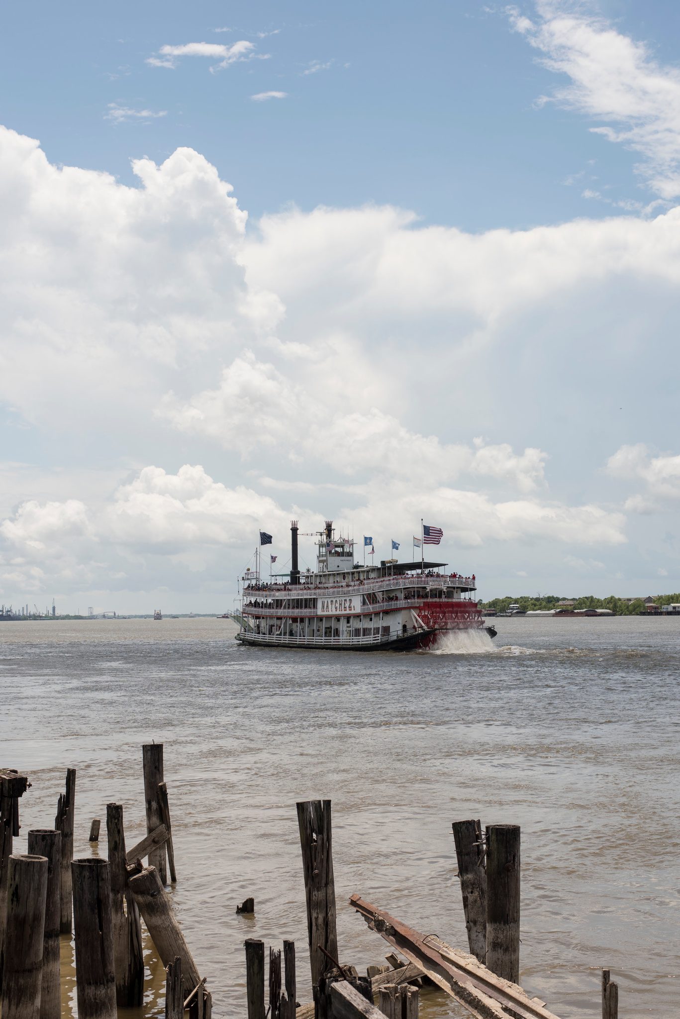 The steamboat Natchez churns up the Mississippi past the broken pilings.
