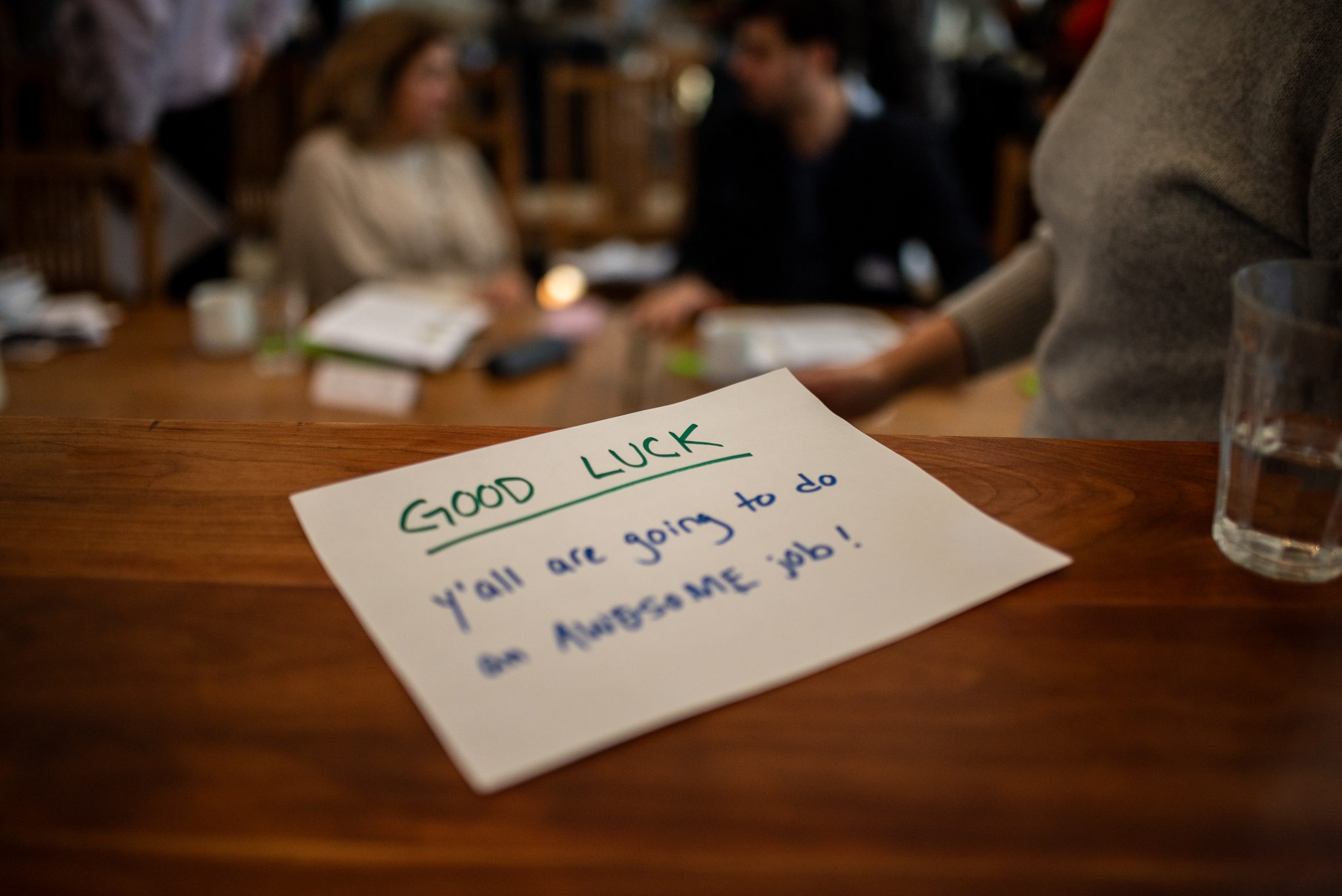 A handwritten note of encouragement waits on the table.