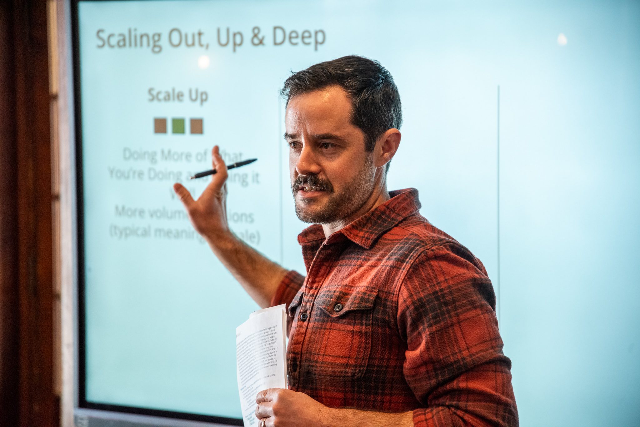 A workshop leader walks the room through ways a farm business can grow.