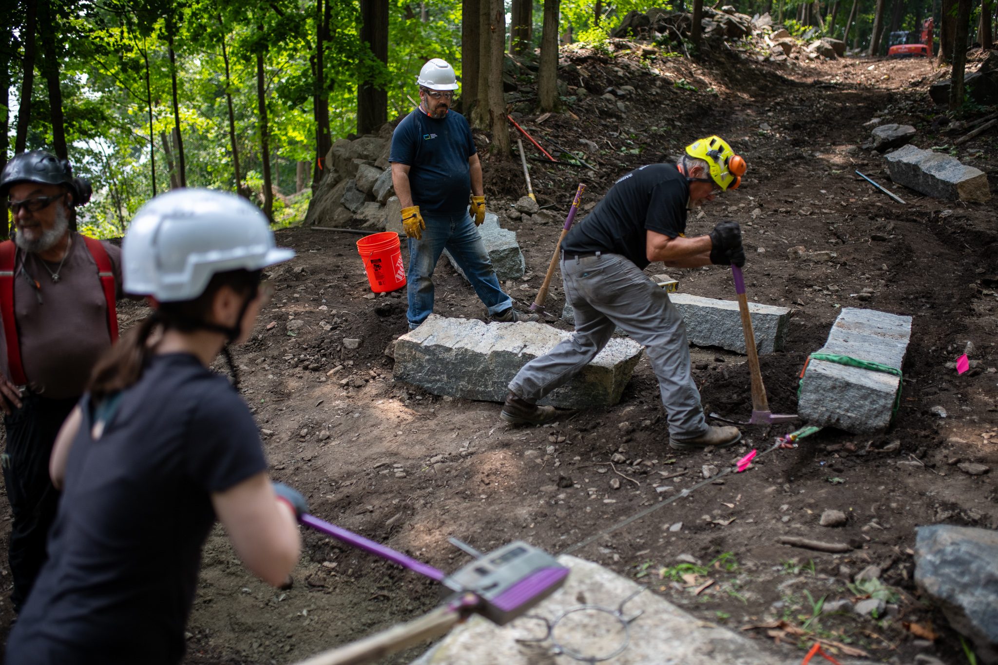 Stone by stone, the crew works up the line of new steps.