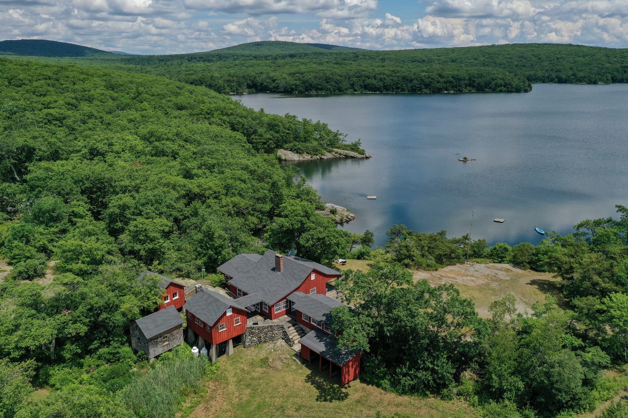 Red barns and cottages cluster on the shore, the lake stretching away between the hills.