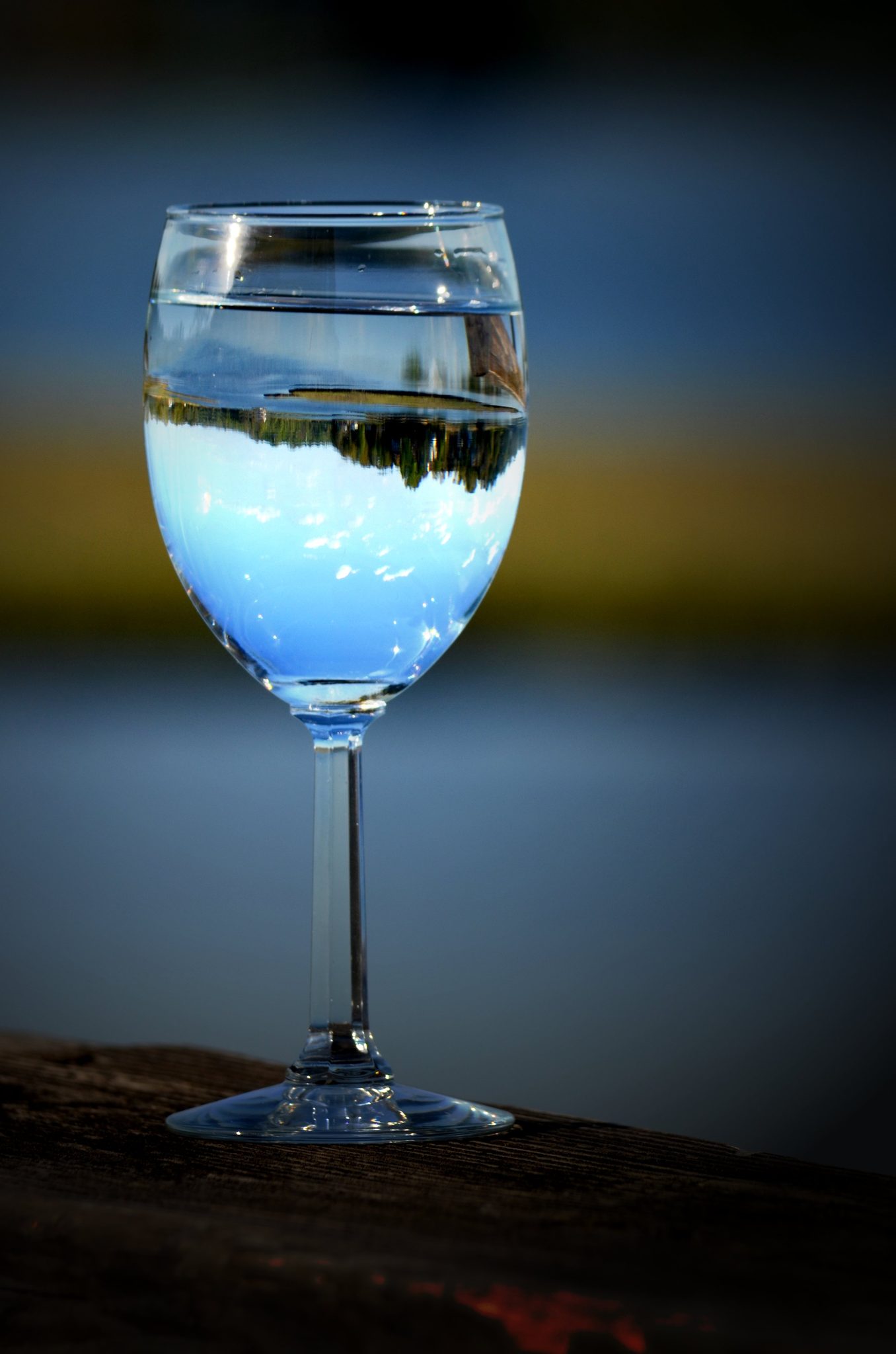 A wine glass holds the whole shoreline upside down. One cannot reflect the beauty around them unless they have seen their beauty within.