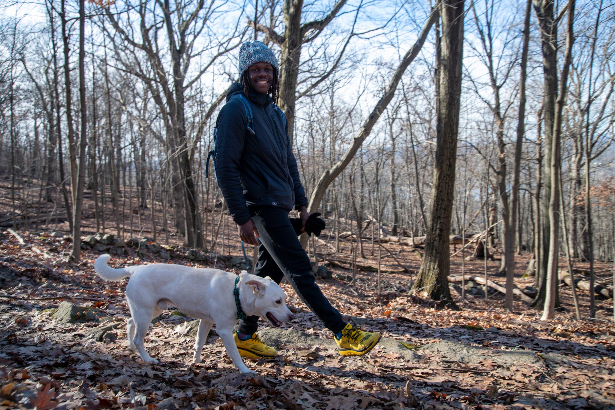 Walking the dog down through the winter woods, Chev smiling with the leash slack.