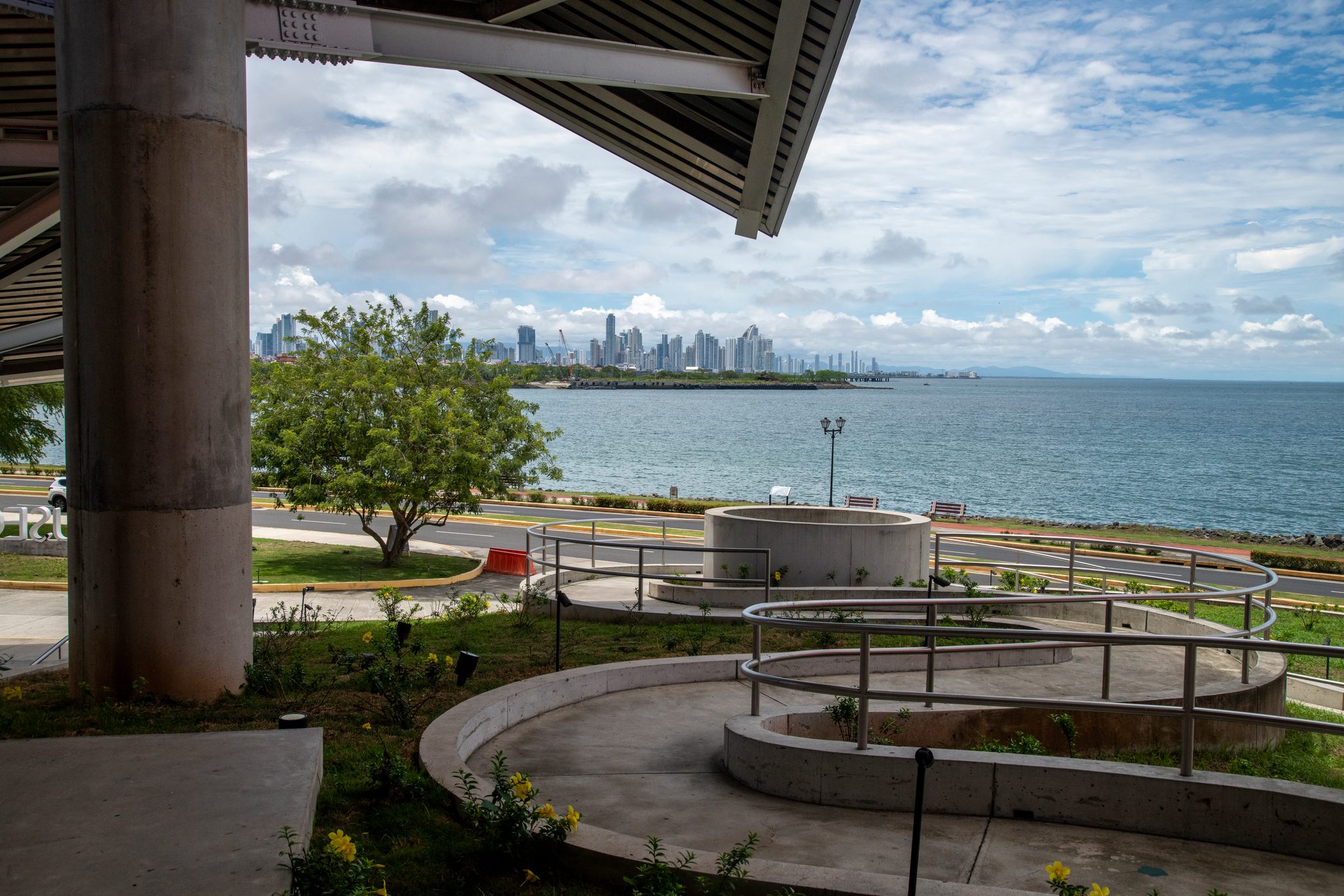 The bay and the city skyline from beneath a museum canopy.