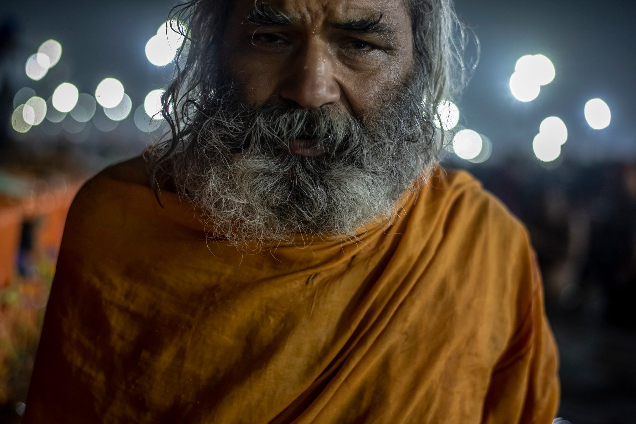 Sadhu stands stoically in the cold waters of