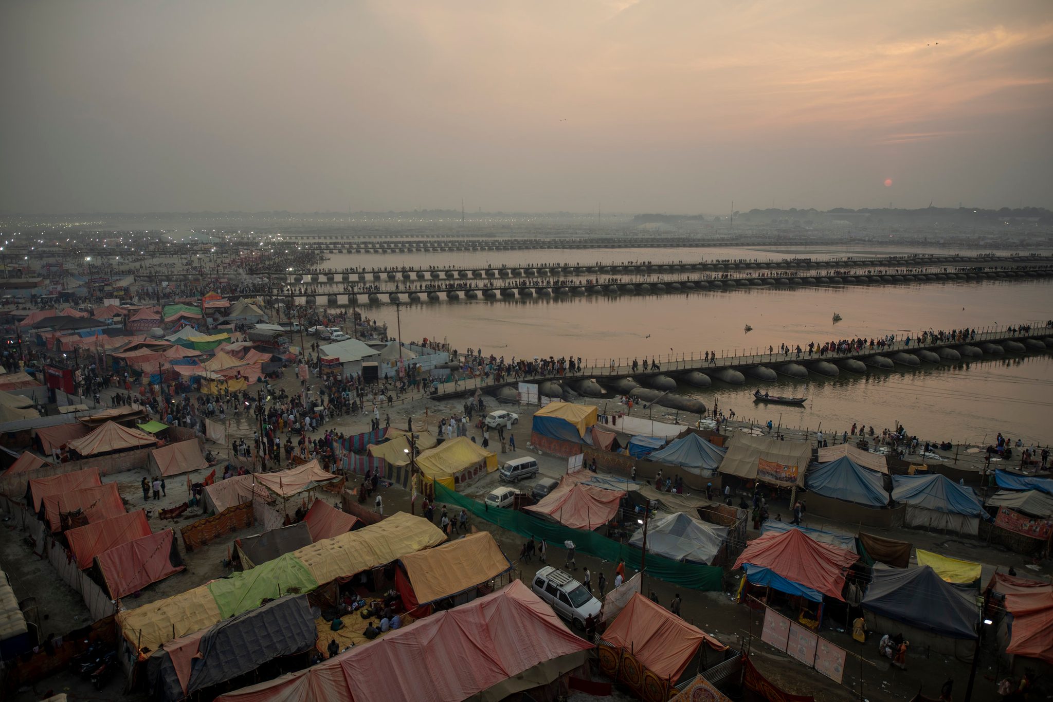 From above, the temporary city sprawls along the river, pontoon bridges stitched across the water.