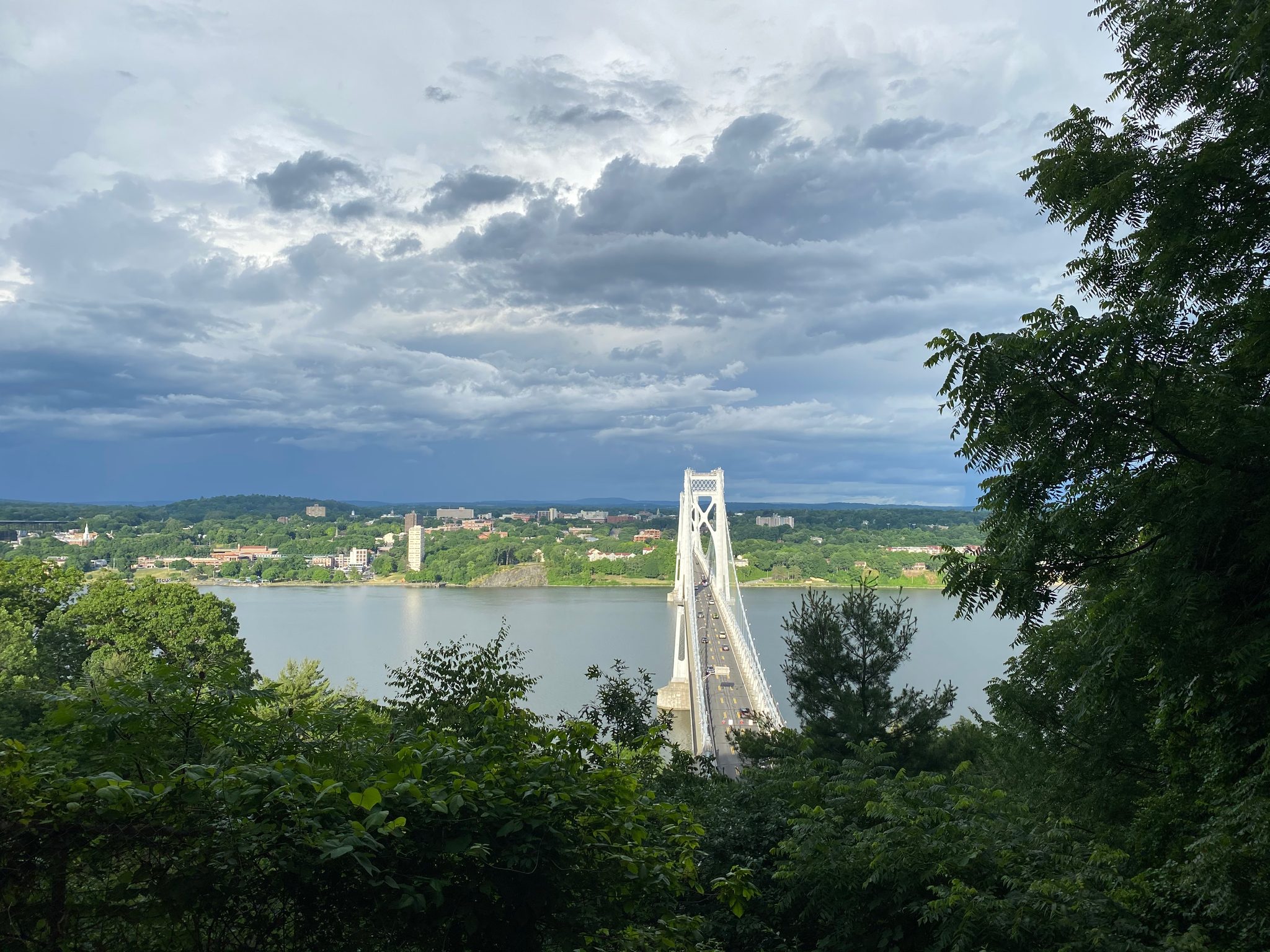Storm clouds build over the river and the bridge tower.