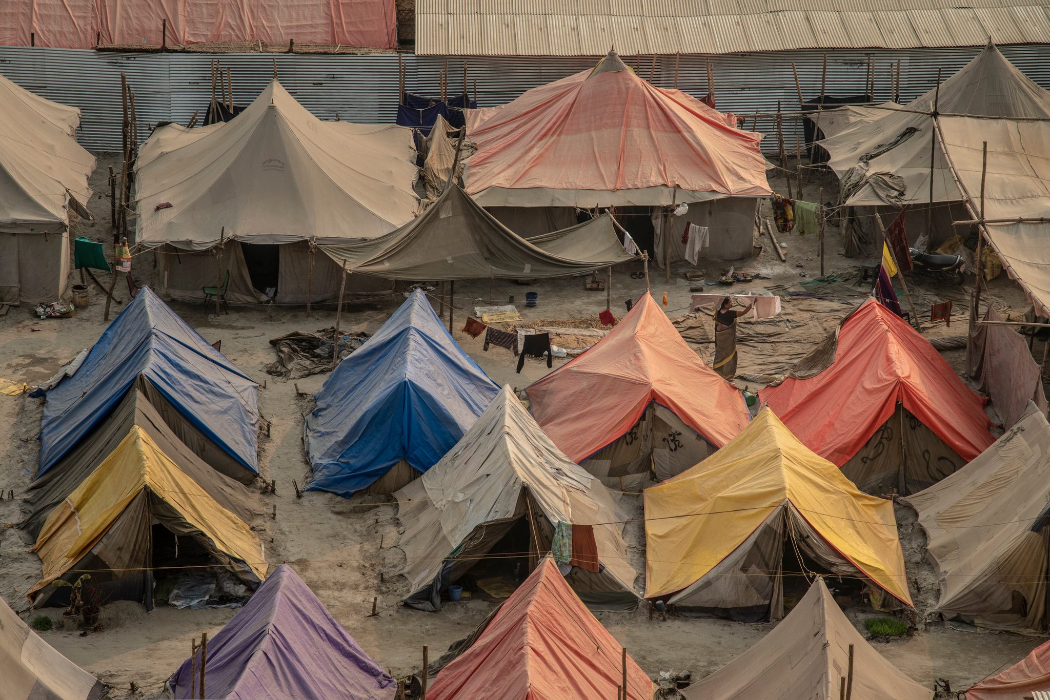 Tents in every color crowd together on the riverbed.