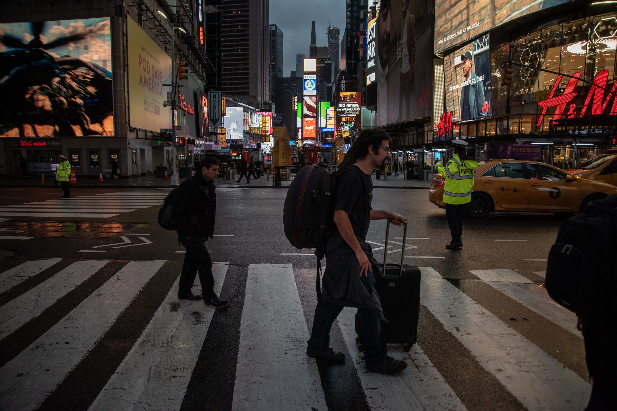 Anthony rolls his case across Times Square before dawn, the billboards already blazing.