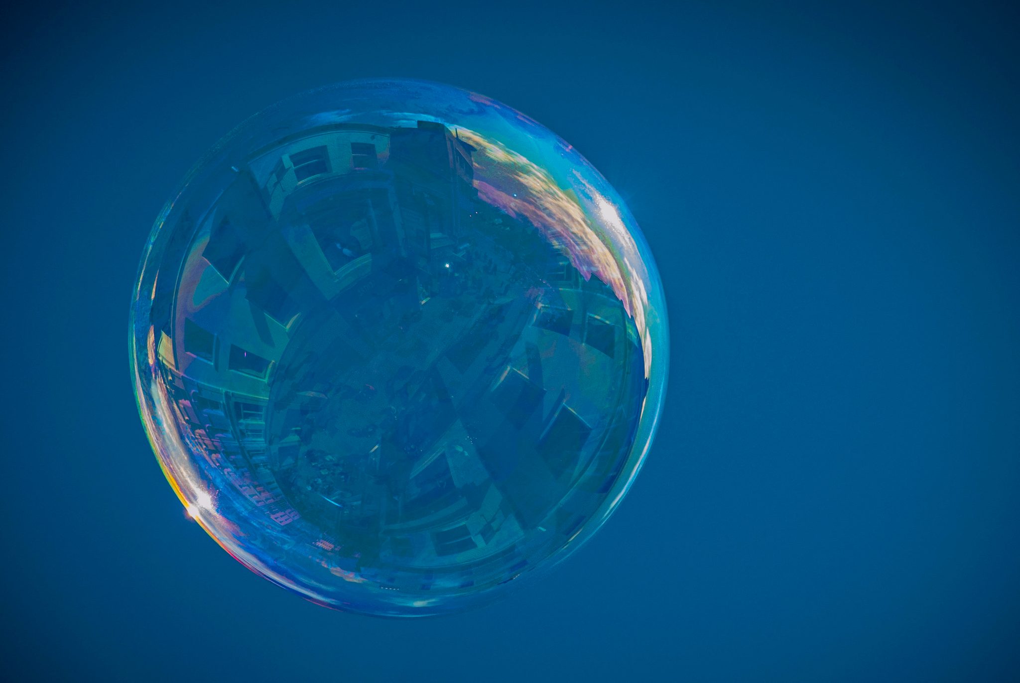 A soap bubble rises with the whole street caught inside it. Up, towards horizons well beyond my view.