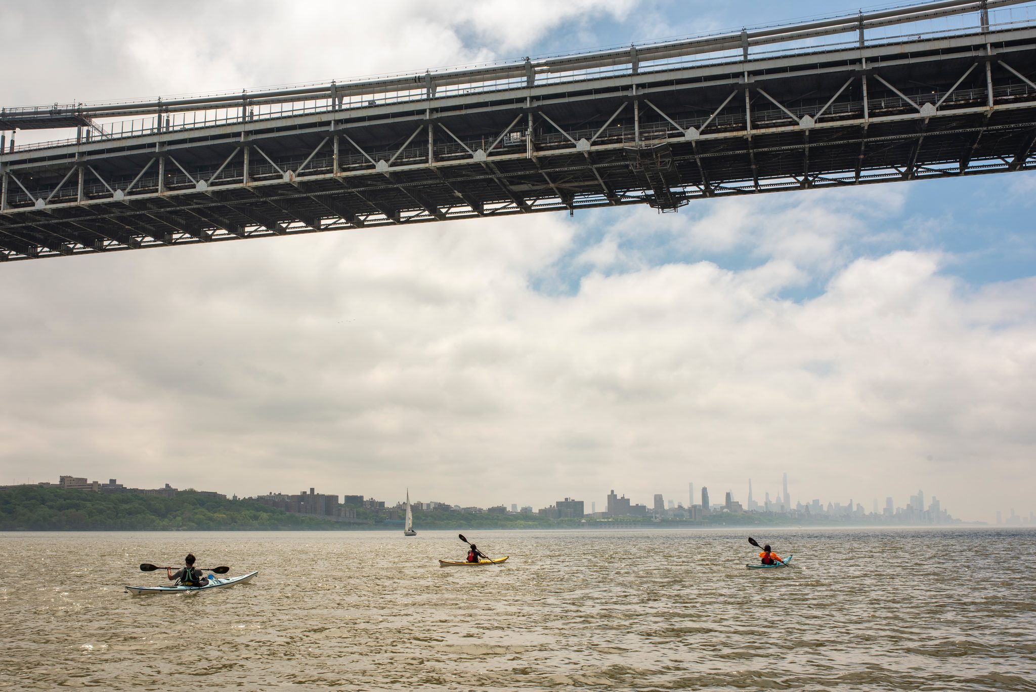 Looking straight up at the steel underside of the bridge deck as the paddlers pass beneath it.