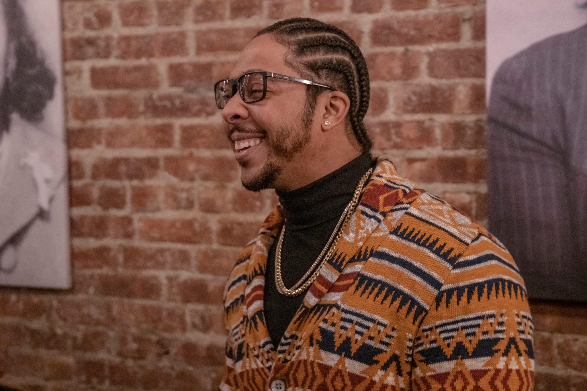A laugh in a patterned cardigan.