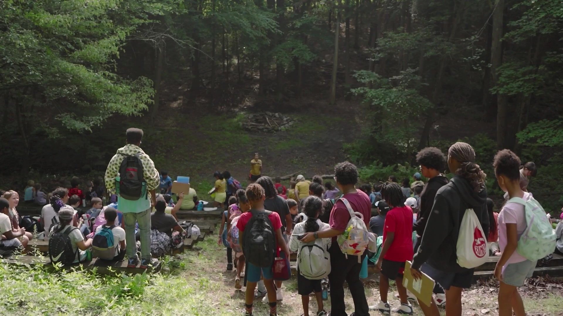Campers gather in the woods before the day begins.
