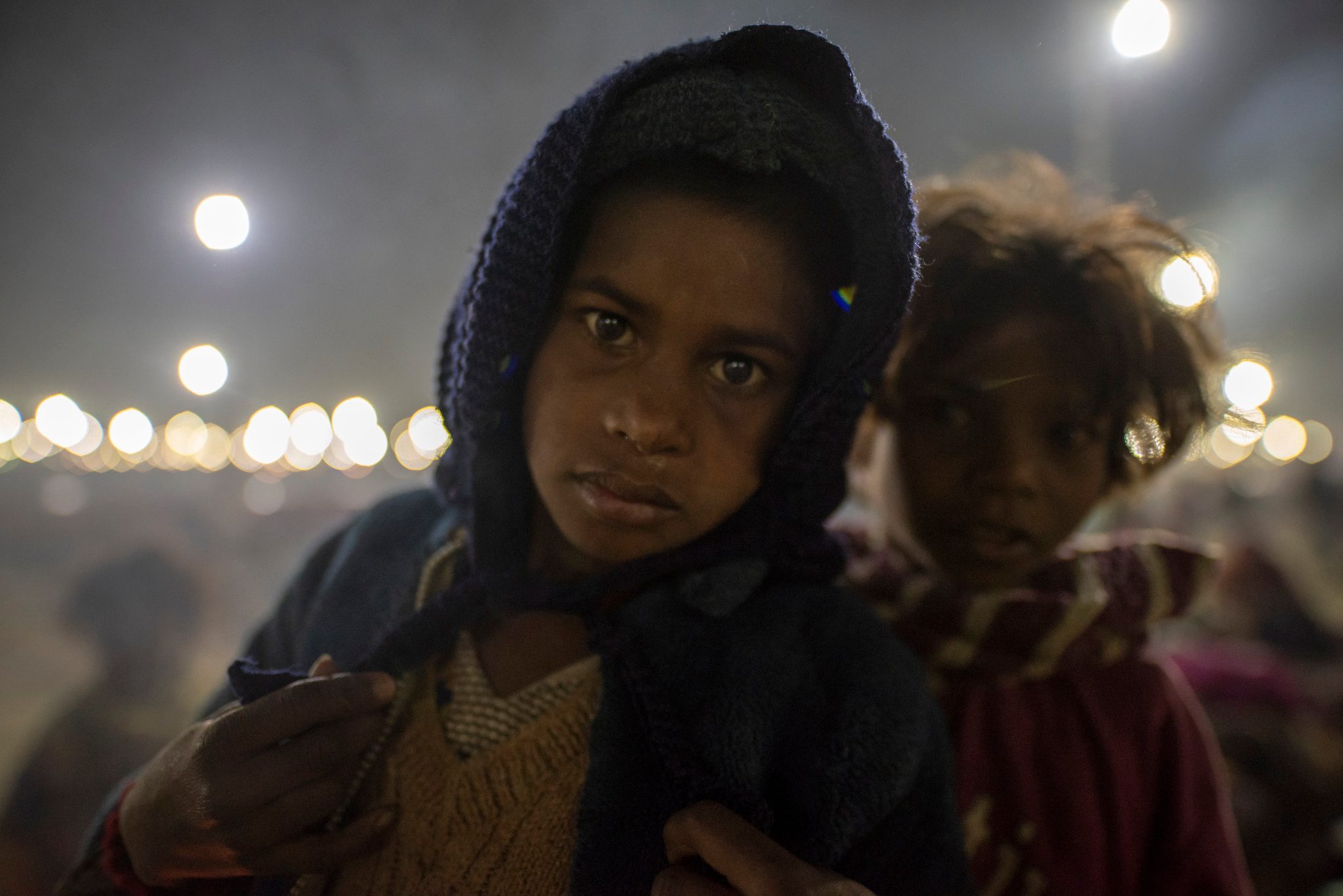 Two young girls await their morning trek to the Ganges