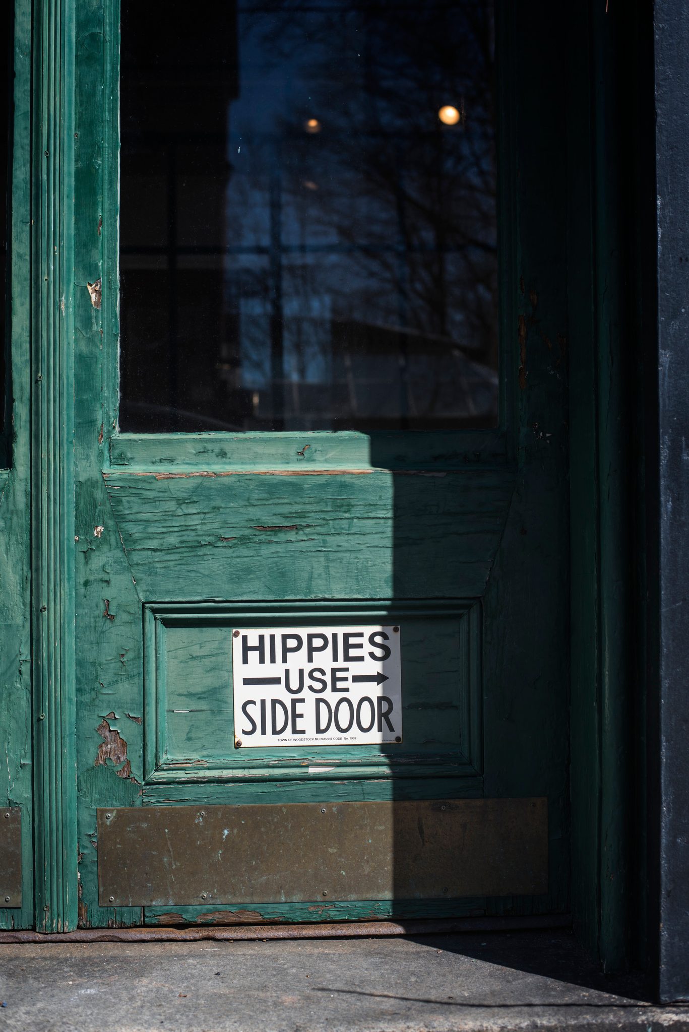 Hippies Use Side Door, says the sign on the green door.